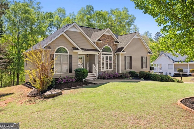 840 Whitby Dr, Douglasville, GA 30134 - view of front facade featuring a shingled roof, stone siding, and a front lawn
