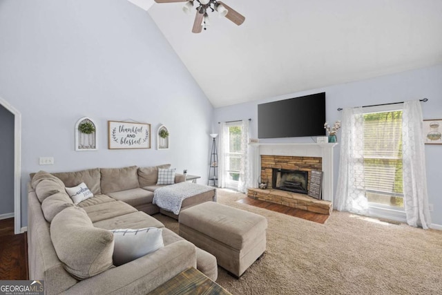 840 Whitby Dr, Douglasville, GA 30134 - living area with baseboards, ceiling fan, carpet, a fireplace, and high vaulted ceiling
