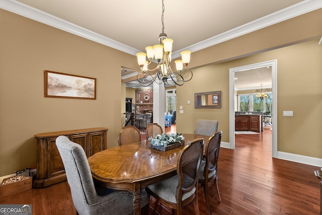 176 Stamp Mill Ln, Dahlonega, GA 30533 - dining space featuring crown molding, an inviting chandelier, baseboards, and dark wood-style flooring
