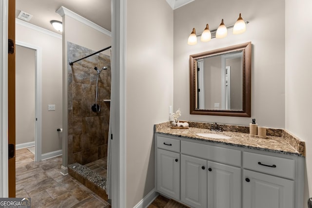 176 Stamp Mill Ln, Dahlonega, GA 30533 - full bathroom with a tile shower, crown molding, vanity, visible vents, and baseboards