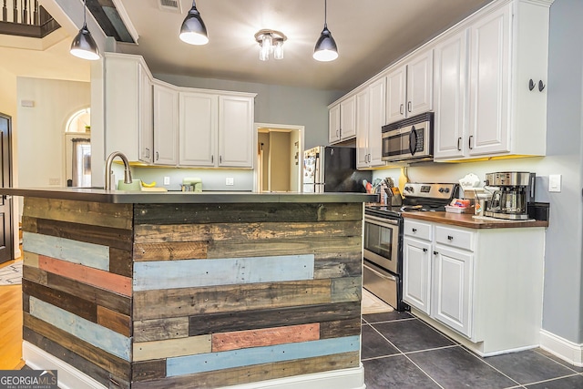 208 Jasmine Ln, Lagrange, GA 30241 - kitchen with dark countertops, stainless steel appliances, and white cabinetry