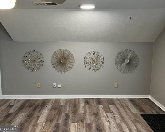 interior details featuring visible vents, baseboards, and wood finished floors