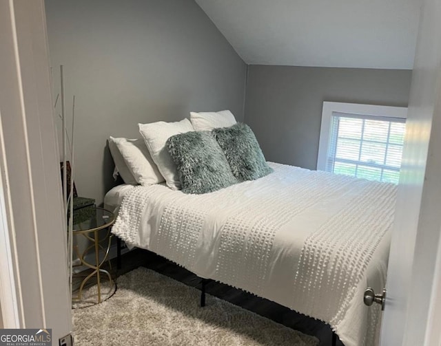 bedroom featuring carpet flooring and vaulted ceiling