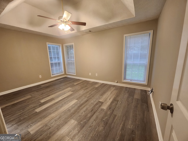 spare room with visible vents, baseboards, a ceiling fan, and wood finished floors