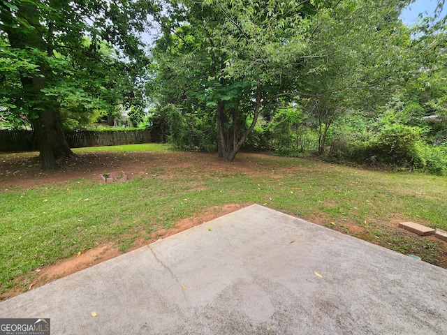 view of yard with fence and a patio