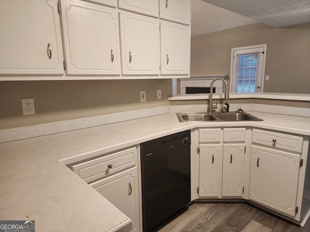 kitchen featuring light countertops, white cabinets, dark wood finished floors, dishwasher, and a sink