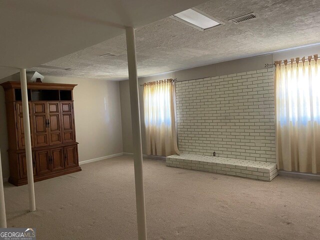 3021 Tiffin Cir, Macon, GA 31204 - basement with a textured ceiling, plenty of natural light, visible vents, and carpet flooring