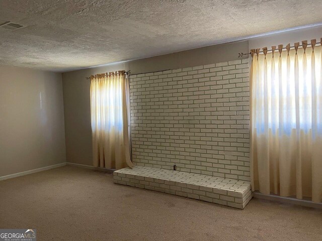 3021 Tiffin Cir, Macon, GA 31204 - unfurnished living room featuring visible vents, baseboards, carpet, and a textured ceiling