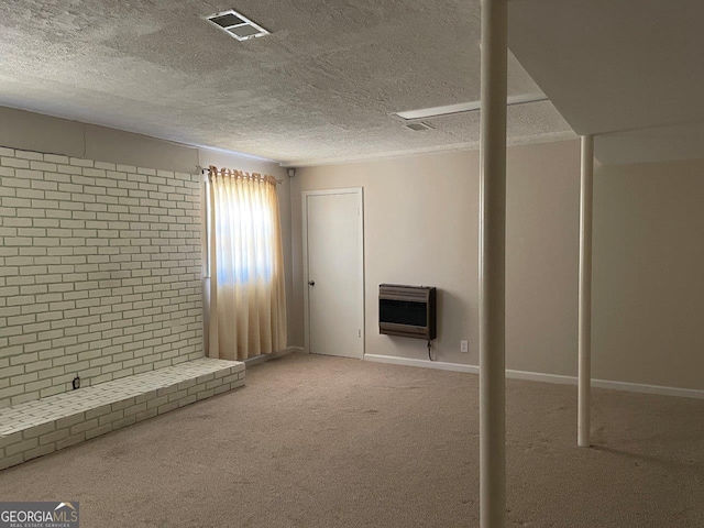 3021 Tiffin Cir, Macon, GA 31204 - below grade area with a textured ceiling, visible vents, carpet flooring, and heating unit