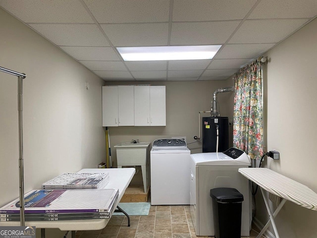 3021 Tiffin Cir, Macon, GA 31204 - washroom with a sink, stone finish floor, water heater, independent washer and dryer, and cabinet space
