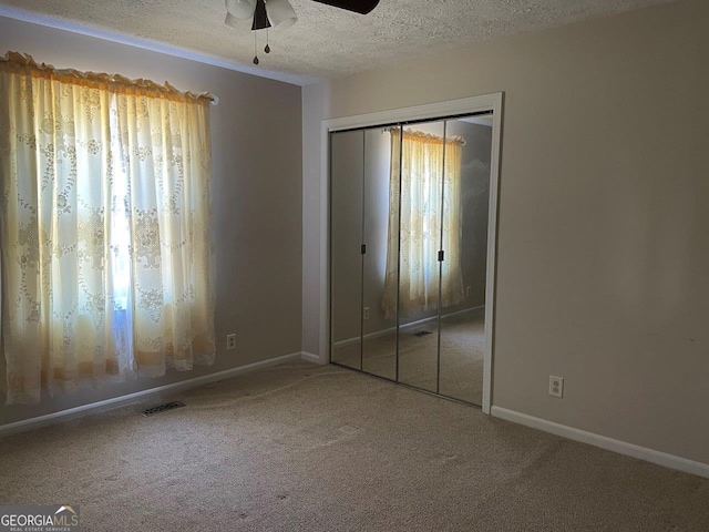 3021 Tiffin Cir, Macon, GA 31204 - unfurnished bedroom featuring carpet, visible vents, a closet, baseboards, and a textured ceiling