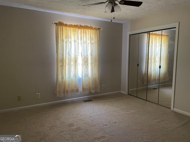 3021 Tiffin Cir, Macon, GA 31204 - unfurnished bedroom featuring carpet floors, visible vents, multiple windows, and a textured ceiling