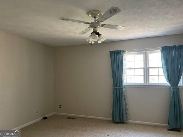 3021 Tiffin Cir, Macon, GA 31204 - empty room featuring a textured ceiling, ceiling fan, light carpet, baseboards, and visible vents