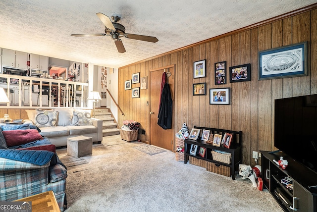1292 Marcelle Heights Pl NW, Norcross, GA 30093 - carpeted living area featuring ceiling fan, stairway, wood walls, and crown molding