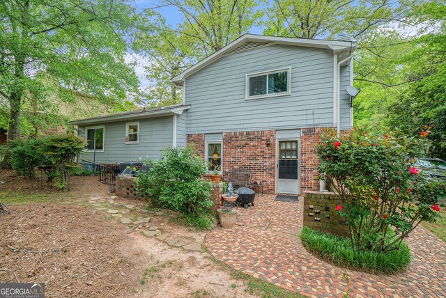 1292 Marcelle Heights Pl NW, Norcross, GA 30093 - rear view of property with brick siding and a patio area