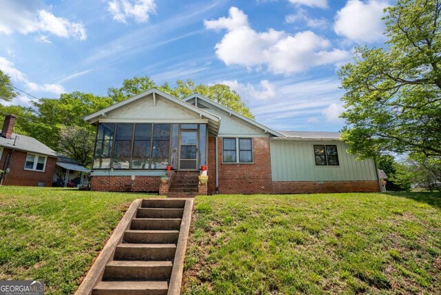 5 Seventh St, Gainesville, GA 30504 - view of front of home featuring a front lawn and a sunroom