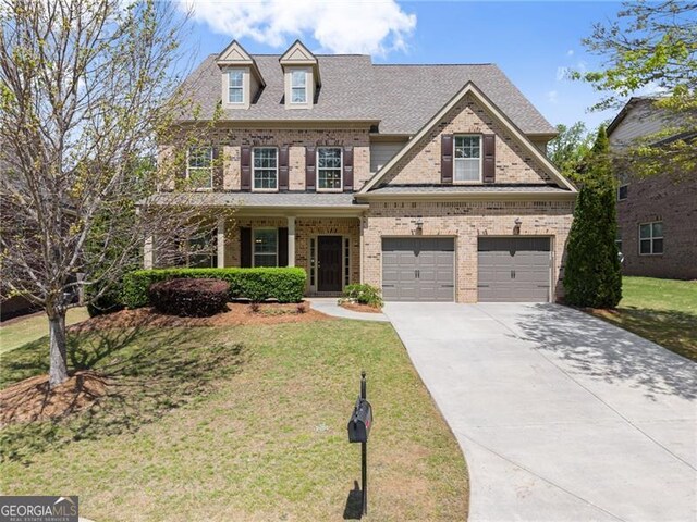 view of front of property with a front lawn, brick siding, an attached garage, a shingled roof, and driveway