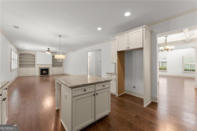 kitchen with open floor plan, dark wood finished floors, a wealth of natural light, and ceiling fan with notable chandelier