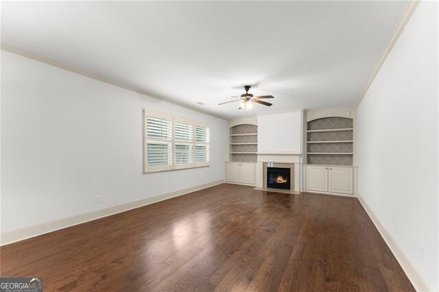 unfurnished living room with dark wood-style floors, a ceiling fan, and crown molding