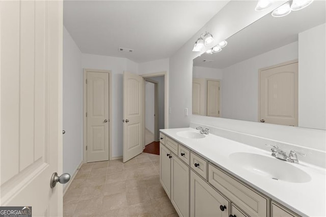 full bathroom with a sink, visible vents, and double vanity