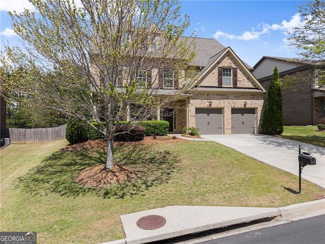 view of front facade featuring a front yard, a garage, fence, brick siding, and driveway
