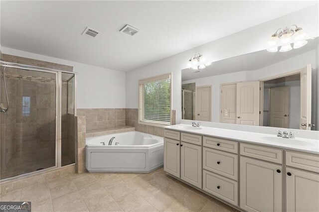 full bathroom featuring a shower stall, double vanity, a sink, and visible vents