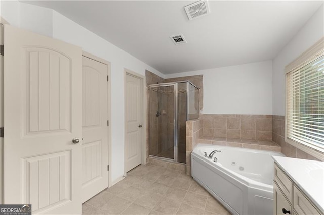 full bathroom featuring a shower stall, vanity, a whirlpool tub, and visible vents