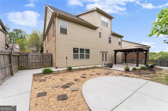 back of house featuring a gazebo, a patio, and fence private yard