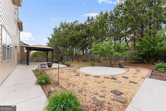 view of yard with a patio area, a fenced backyard, a gazebo, and an outdoor fire pit