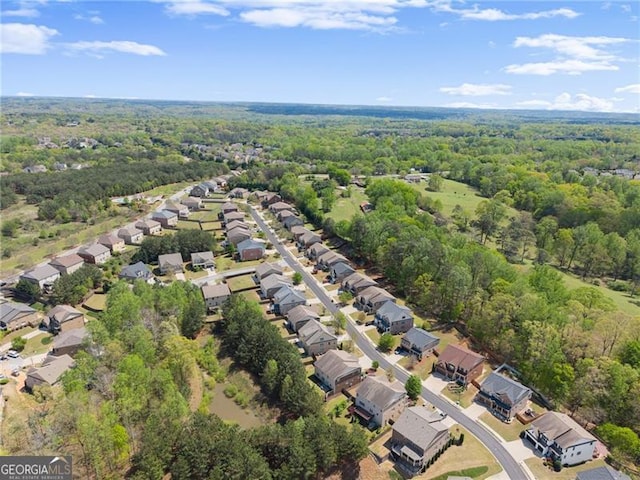 birds eye view of property with a wooded view and a residential view