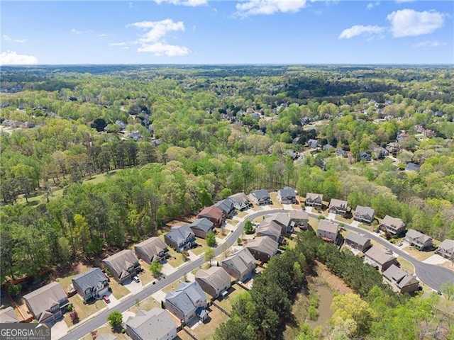 bird's eye view with a wooded view and a residential view