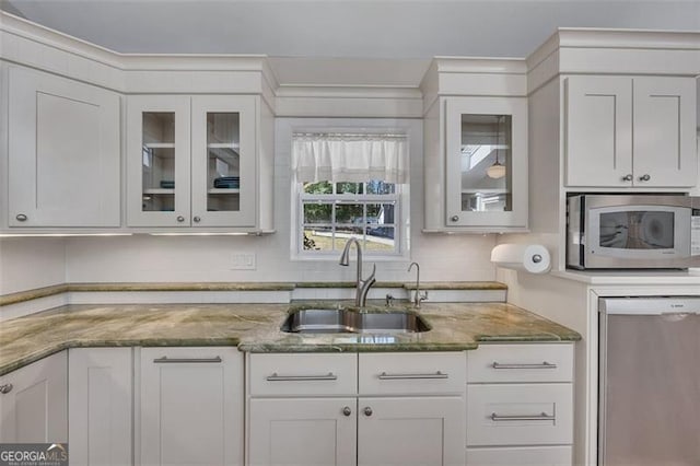 934 Pine Cir, Woodstock, GA 30189 - kitchen featuring white cabinets, light stone countertops, a sink, and appliances with stainless steel finishes