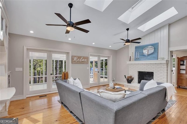 934 Pine Cir, Woodstock, GA 30189 - living room with light wood-style floors, french doors, a ceiling fan, and a healthy amount of sunlight