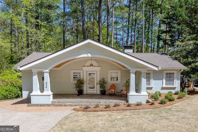 934 Pine Cir, Woodstock, GA 30189 - exterior space with roof with shingles, stucco siding, and covered porch
