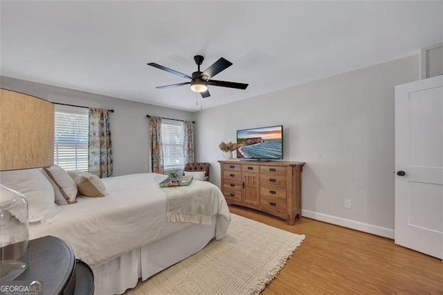 934 Pine Cir, Woodstock, GA 30189 - bedroom with ceiling fan, light wood finished floors, and baseboards