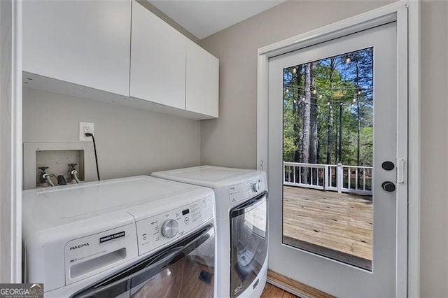 934 Pine Cir, Woodstock, GA 30189 - clothes washing area featuring wood finished floors, washing machine and dryer, and cabinet space