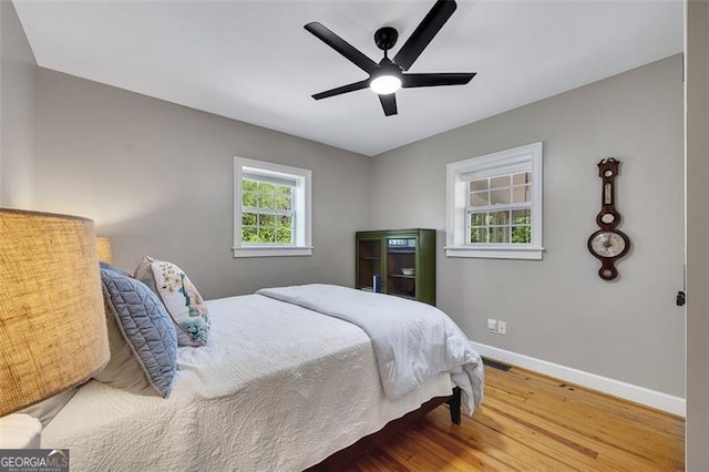 934 Pine Cir, Woodstock, GA 30189 - bedroom featuring wood finished floors, baseboards, a ceiling fan, and visible vents