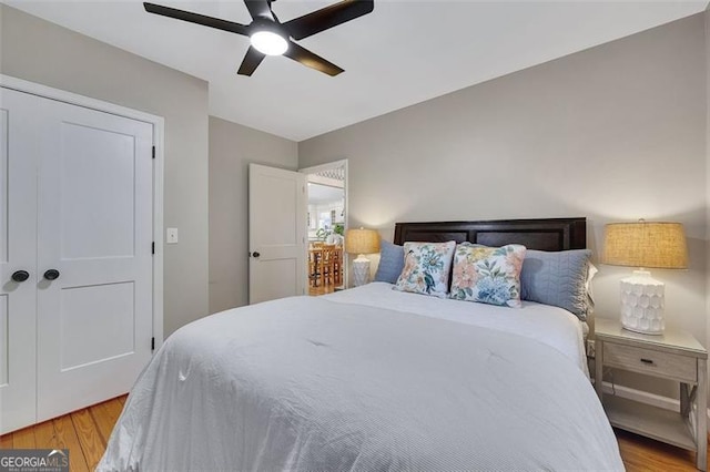 934 Pine Cir, Woodstock, GA 30189 - bedroom featuring ceiling fan and wood finished floors