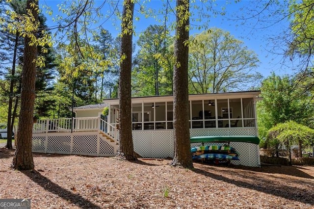 934 Pine Cir, Woodstock, GA 30189 - back of property with a sunroom, a wooden deck, ceiling fan, and stairway