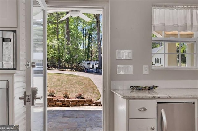 934 Pine Cir, Woodstock, GA 30189 - doorway with stone finish floor and a ceiling fan