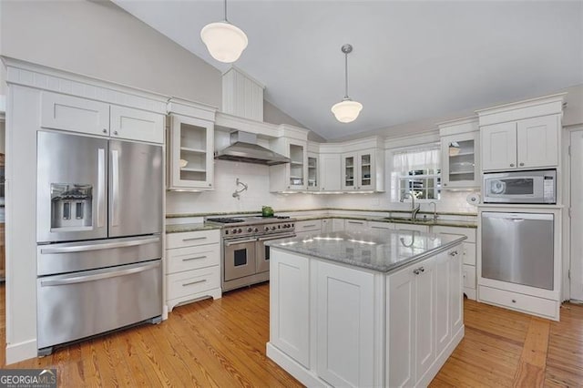 934 Pine Cir, Woodstock, GA 30189 - kitchen featuring a sink, wall chimney range hood, white cabinetry, stainless steel appliances, and lofted ceiling