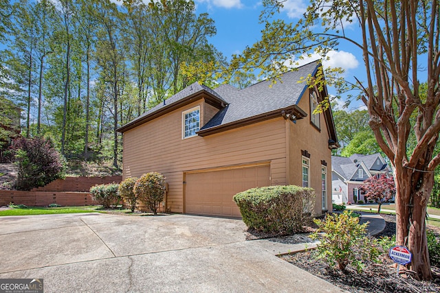 4609 Mctyre Way NW, Marietta, GA 30064 - view of side of property featuring driveway, an attached garage, and roof with shingles