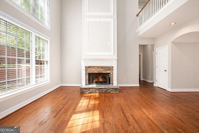 4609 Mctyre Way NW, Marietta, GA 30064 - unfurnished living room with a high ceiling, a fireplace, and wood finished floors
