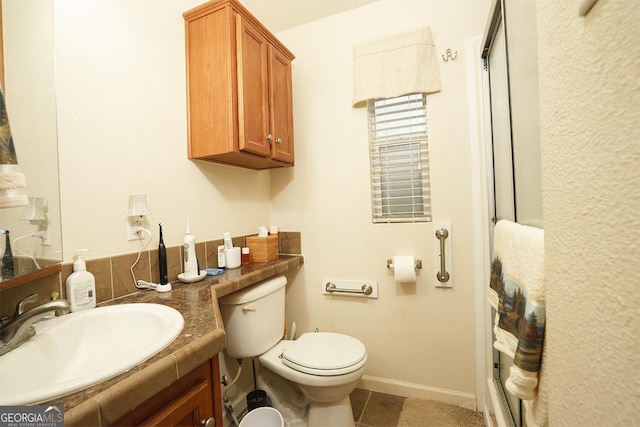 bathroom featuring an enclosed shower, tile patterned flooring, vanity, baseboards, and toilet