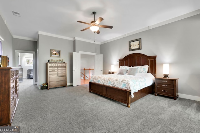 bedroom featuring visible vents, ornamental molding, light carpet, baseboards, and ceiling fan
