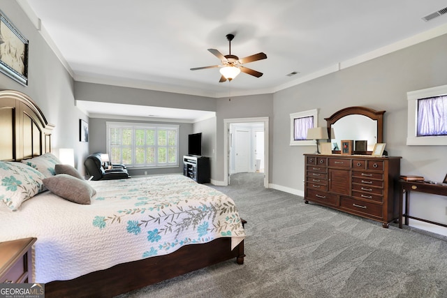 carpeted bedroom featuring baseboards, visible vents, and ornamental molding