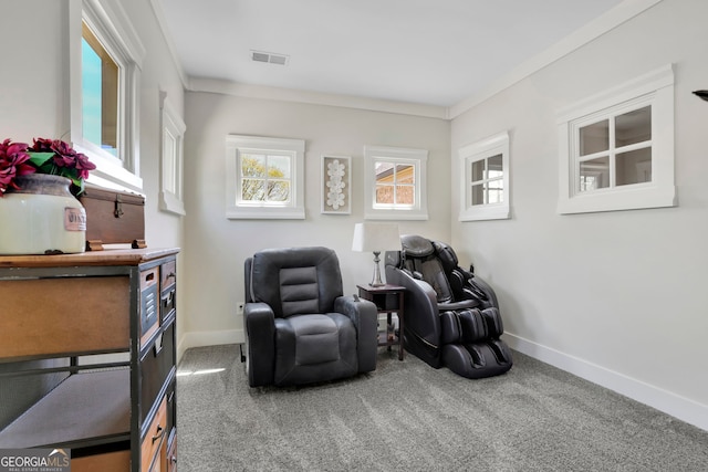 sitting room with crown molding, baseboards, carpet, and visible vents