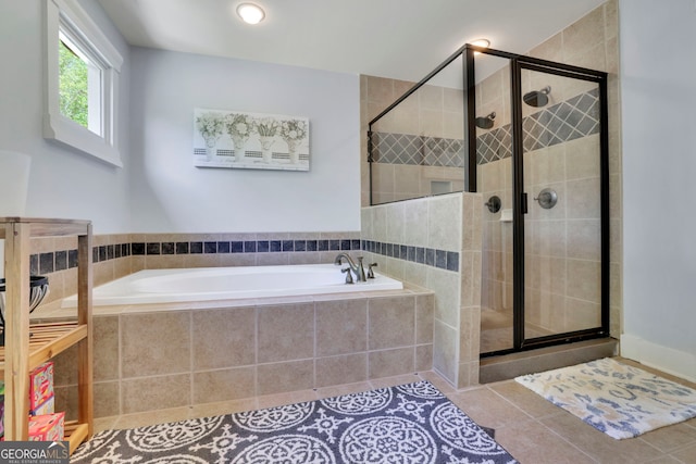 full bath with tile patterned floors, a shower stall, and a garden tub