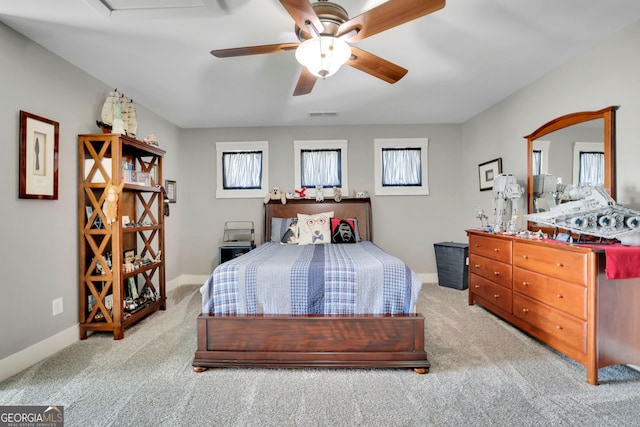 bedroom featuring baseboards, carpet, a ceiling fan, and visible vents