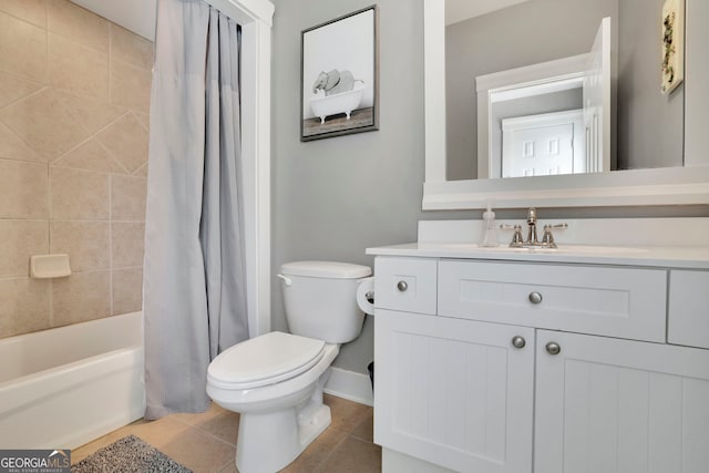 bathroom featuring tile patterned flooring, shower / tub combo, baseboards, vanity, and toilet